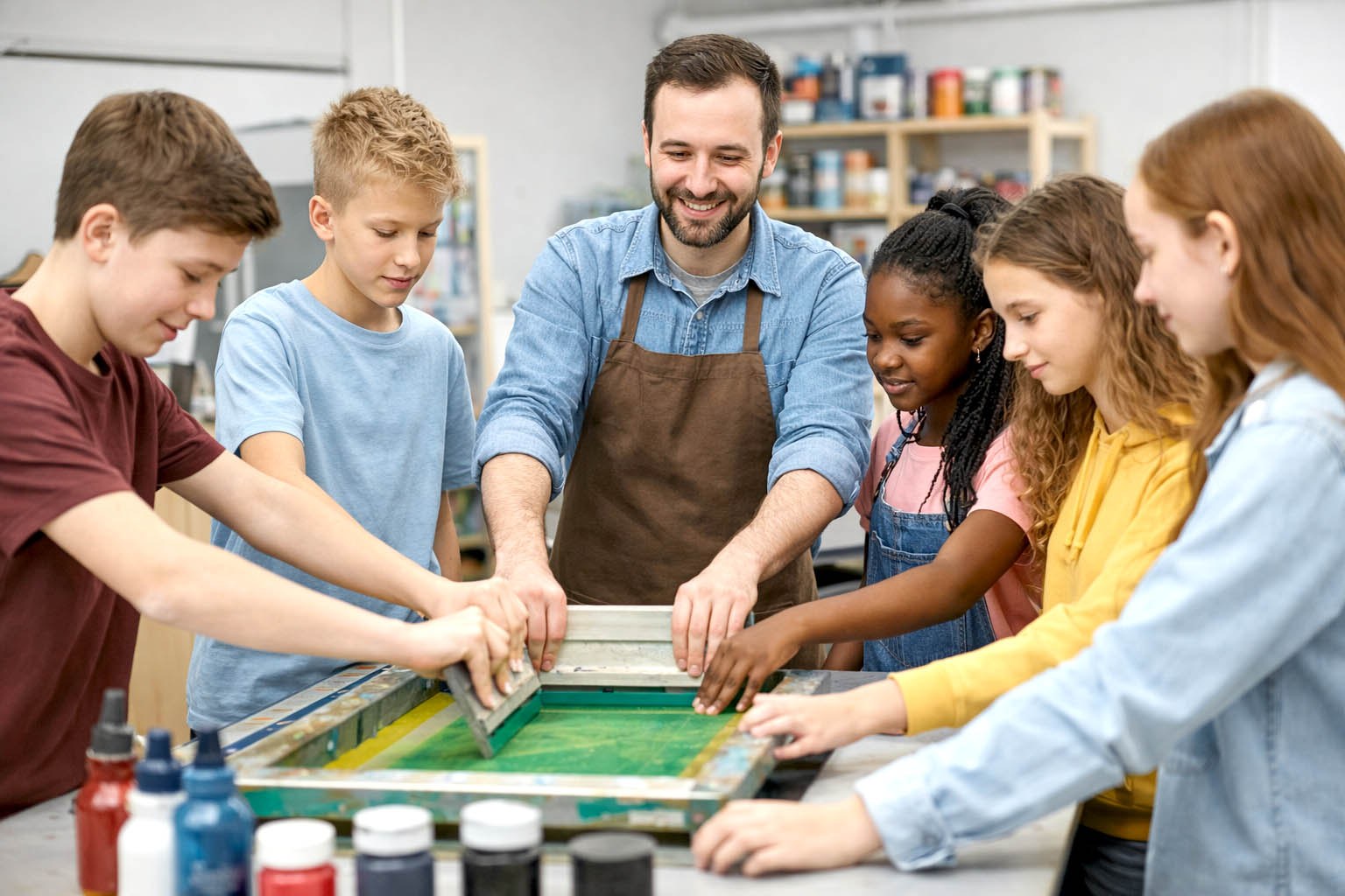 L'insegnante stampa con i suoi studenti serigrafia a scuola